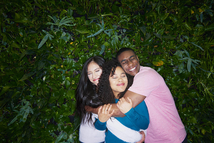 Three Young Adults Hugging Photograph by Tara Moore