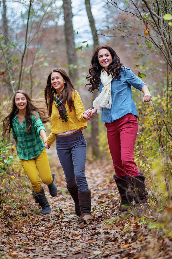 Nature Photograph - Three Young Women Smile & Hold Hands by Corey Nolen