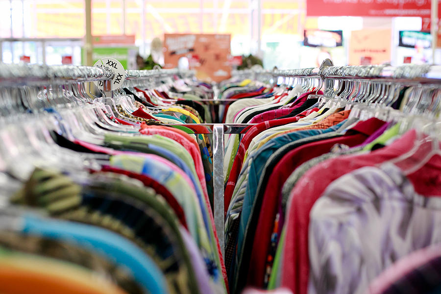 Thrift store clothing racks Photograph by Jennifer M. Ramos