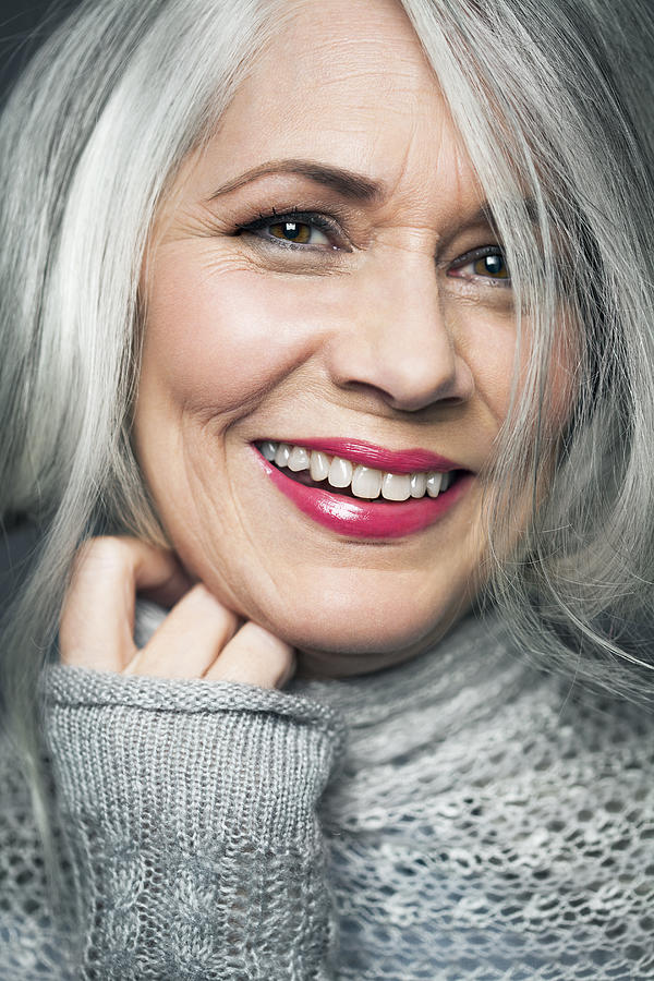 Tight portrait of grey haired lady with red lips. Photograph by Andreas Kuehn