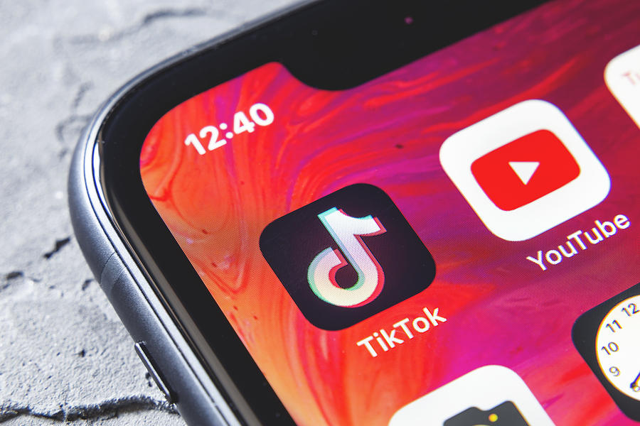 TikTok and YouTube apps on screen iphone xr, close up Photograph by Anatoliy Sizov