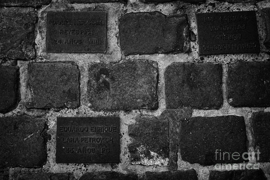 Paris Photograph - tiles in the footpath to those killed or disappeared outside former prison and torture house in calle londres barrio paris londres Santiago Chile by Joe Fox