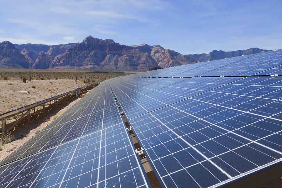 Tilted solar panels, near the mountains of the Mojave Desert Photograph by Andreiorlov