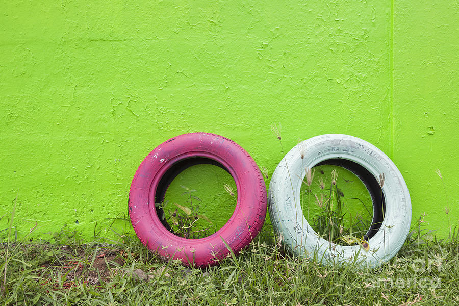 Tires Painted In Bright Color Leaning Against Wall in San Juan Pu Photograph by Bryan Mullennix