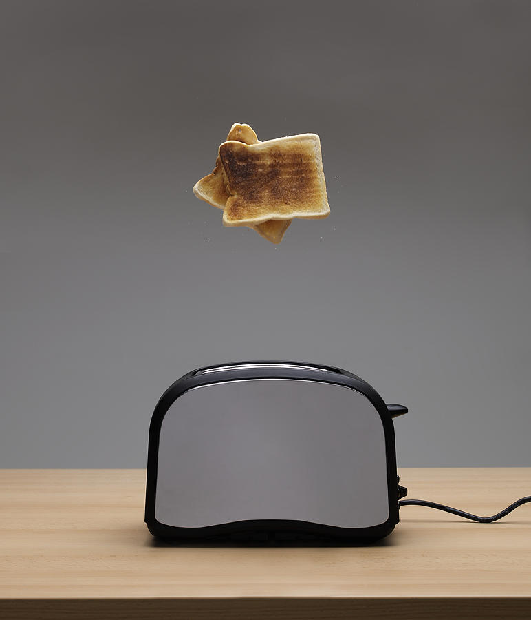 Toaster ejecting toast Photograph by Mike Harrington