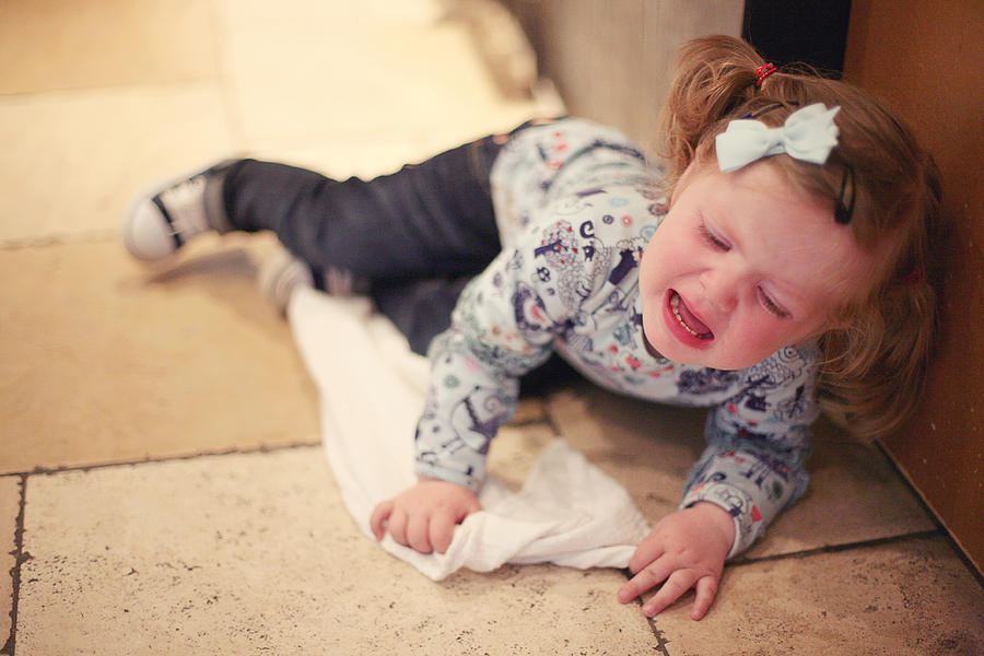 Toddler tantrum on floor Photograph by Jill Tindall