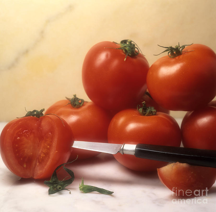 Tomatoes and a knife Photograph by Bernard Jaubert