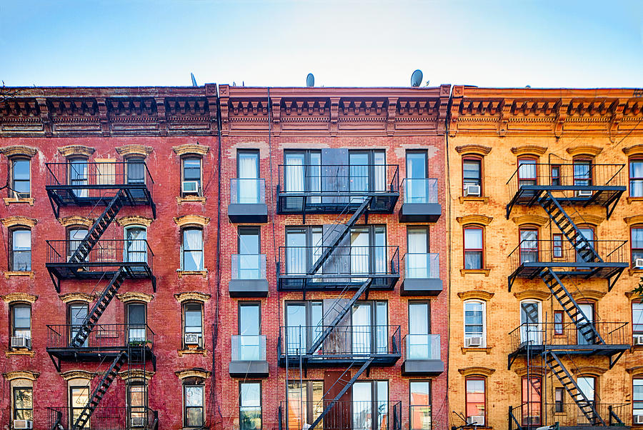 Top stories of colorful Williamsburg apartment buildings with steel fire escape stairways Photograph by NicolasMcComber
