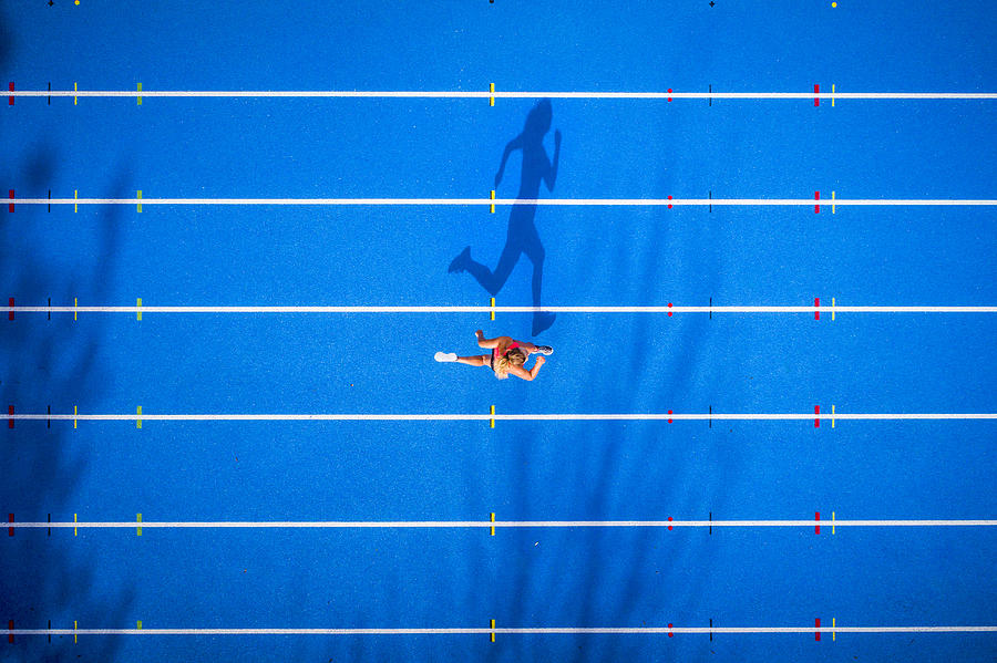 Top view of female runner on tartan track Photograph by Westend61