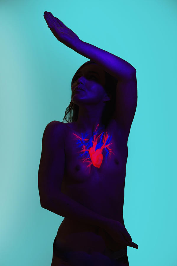 Torso Of A Woman With A Painted Shining Heart Photograph by Matthias Tunger