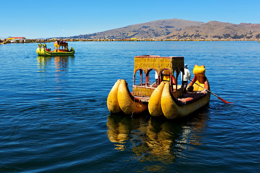 Totora raft offers tourists a boat ride on Lake Titicaca offshore of the floating islands in Puno district of Peru Photograph by Anna Gorin