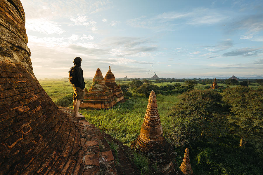 Tourist standing on Bagan Pagoda during sunrise in Myanmar Photograph by Sam Spicer