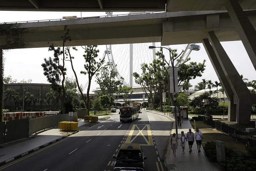 Tourists and traffic on the route leading to the Singapore Flyer Photograph by Ashish Agarwal