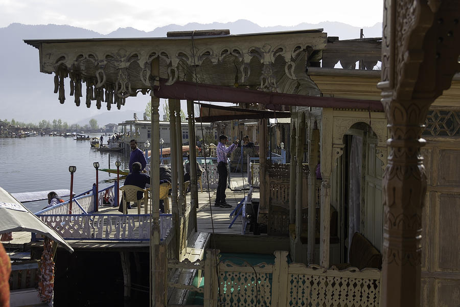 Tourists at the front section of houseboats lined up along Dal Lake Photograph by Ashish Agarwal