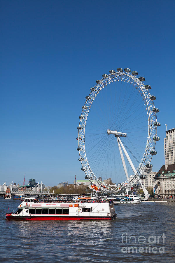 Tourists boat on the Thames and London Eye. Photograph by Peter Noyce