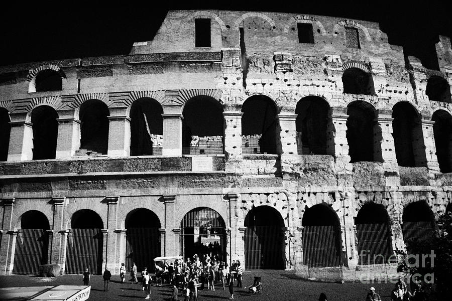 Architecture Photograph - Tourists exit the rear entrance to the colosseum Rome Lazio Italy by Joe Fox