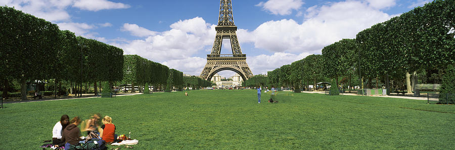 Architecture Photograph - Tourists Sitting In A Park With A Tower by Panoramic Images