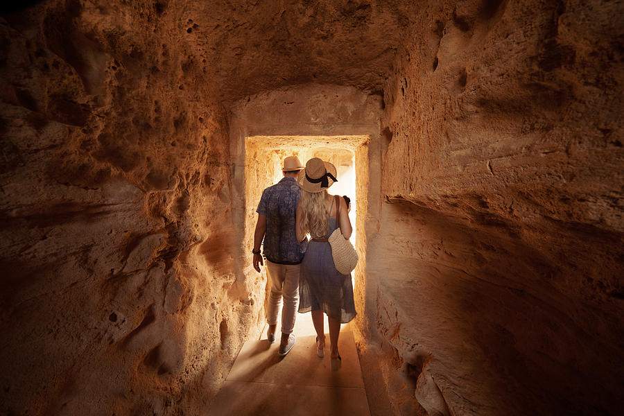 Tourists walking in dark passage at archaeological site in Greece Photograph by Wundervisuals