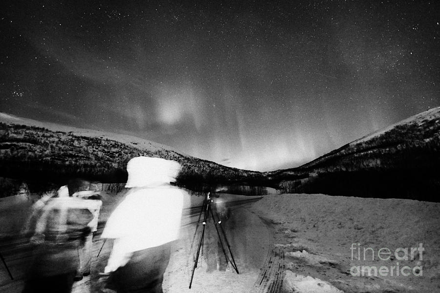 Nature Photograph - Tourists With Tripods And Cameras Et Up To Photograph Northern Lights Aurora Borealis Near Tromso In by Joe Fox