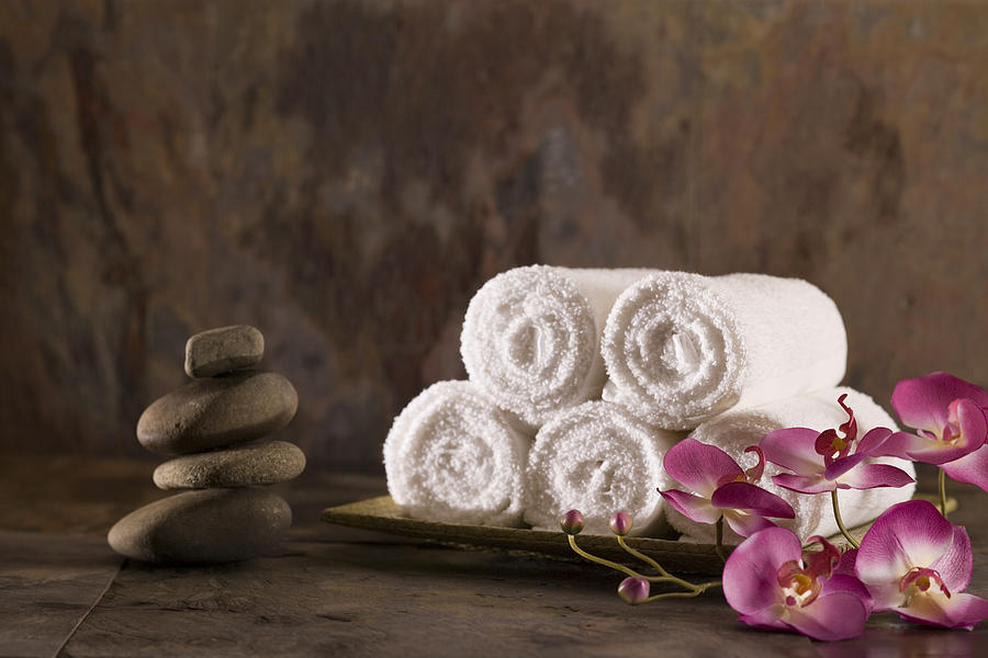 Towels, flowers, and stones Photograph by Comstock Images