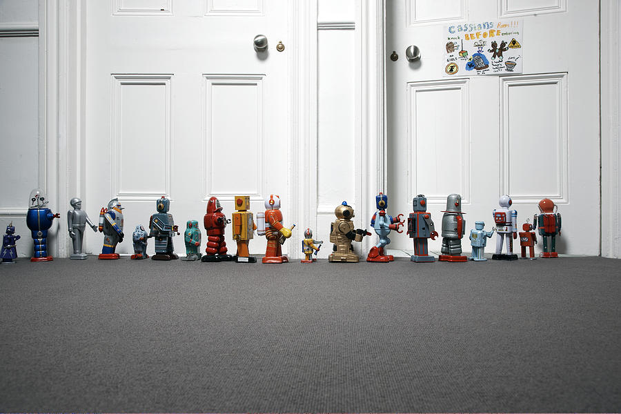 Toy Robots Lined Up Outside Childs Bedroom Photograph by Martin Poole
