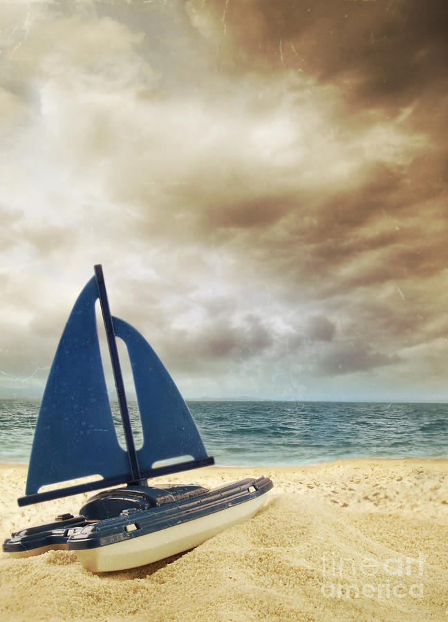 Toy sailboat in the sand with vintage look Photograph by Sandra Cunningham