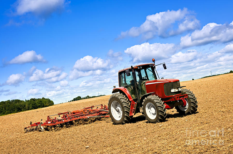 Tractor In Plowed Farm Field Photograph by Elena Elisseeva