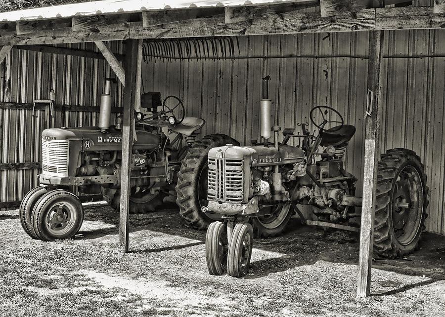 Tractors In The Shed Black and White Photograph by Vic Montgomery