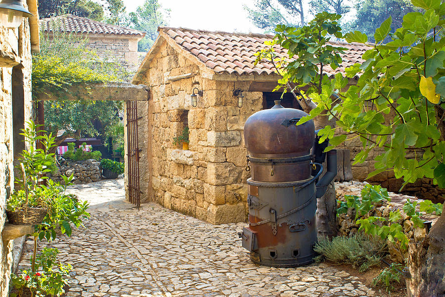 Traditional brandy still in stone village Photograph by Brch Photography