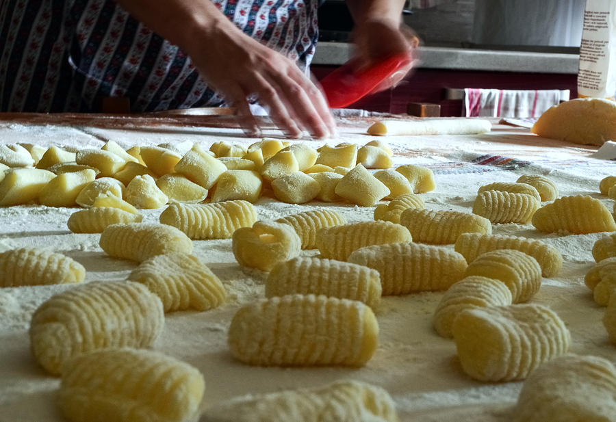 Traditional homemade preparation of fresh, handmade potato gnocchi pasta in Piedmont, Italy Photograph by Smartshots International