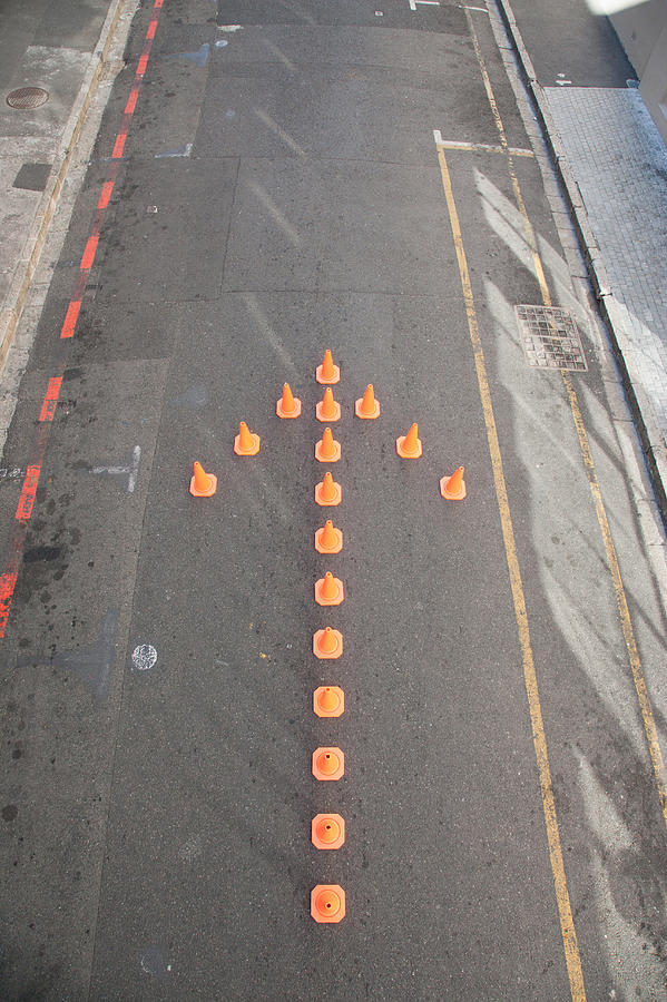 Traffic cones in arrow-shape Photograph by Martin Barraud