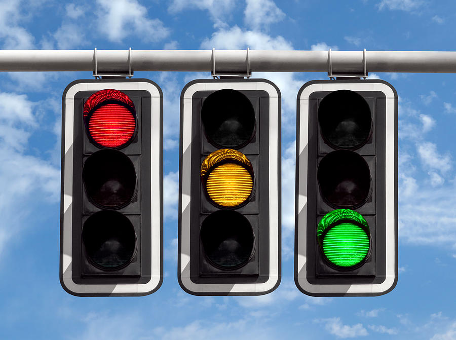 Traffic lights - red yellow green against sky Photograph by Venakr