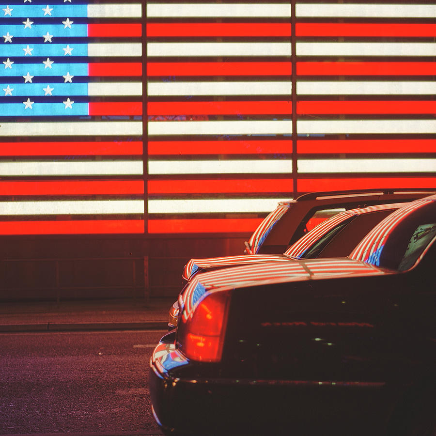 Traffic On Road With American Flag Photograph by Alberto Cassani