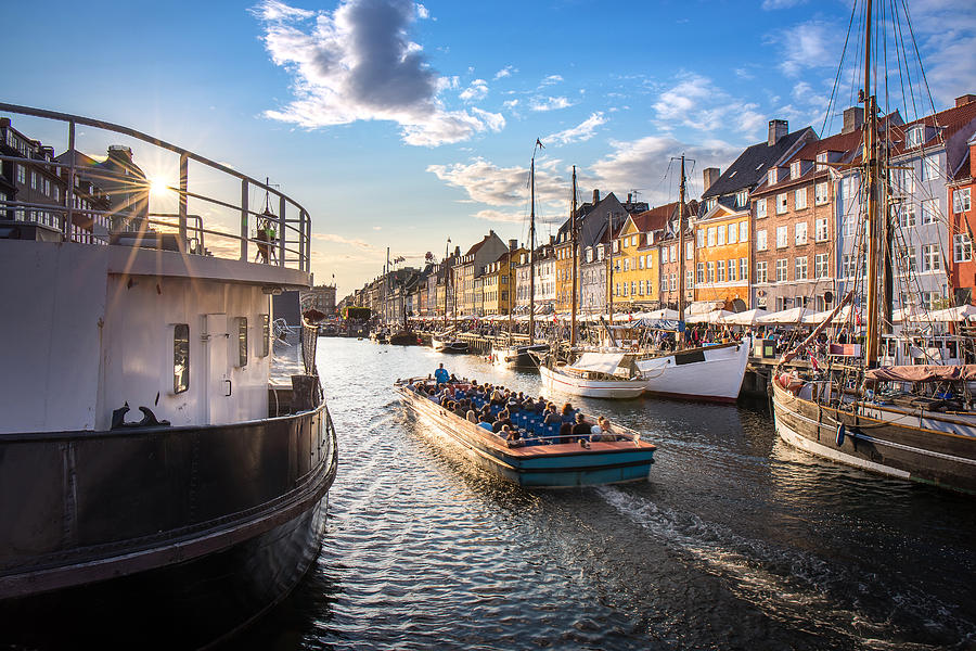 traval cruise with tourist in canal at Nyhavn, colorful building Photograph by KNub
