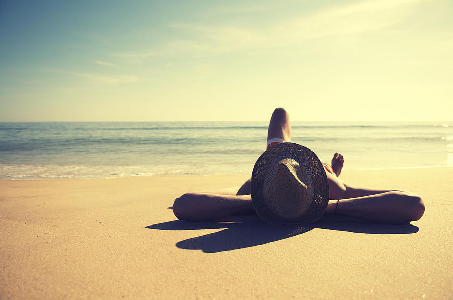 Traveling Man Relaxing on Tranquil Vintage Beach Wearing Hat Photograph by PeskyMonkey