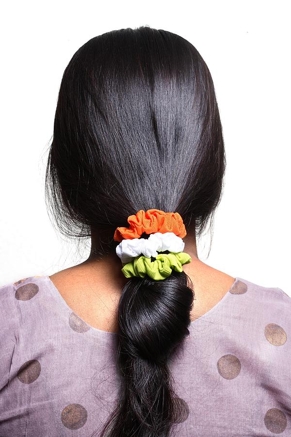 Tri-colored rubber bands on womans hair Photograph by Visage