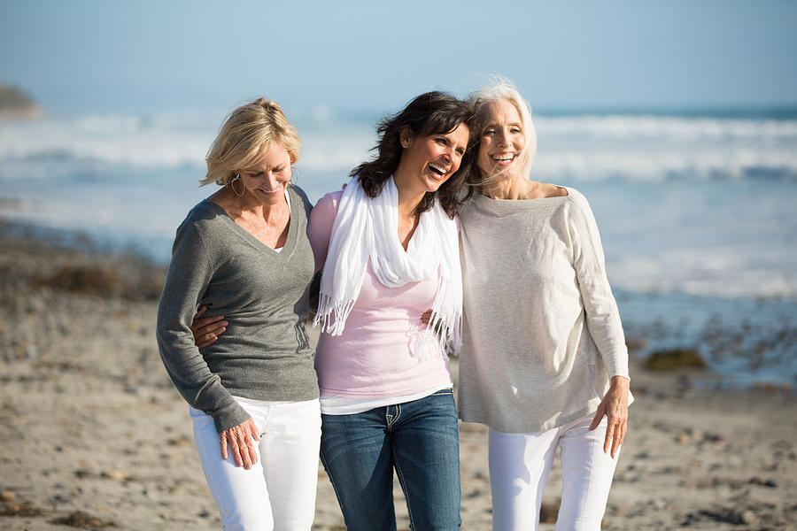 Trio of women walking at the beach Photograph by AMR Image