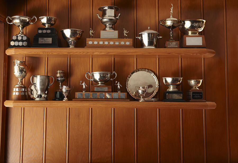 Trophies Lined Up On Display Shelf Photograph by Lwa