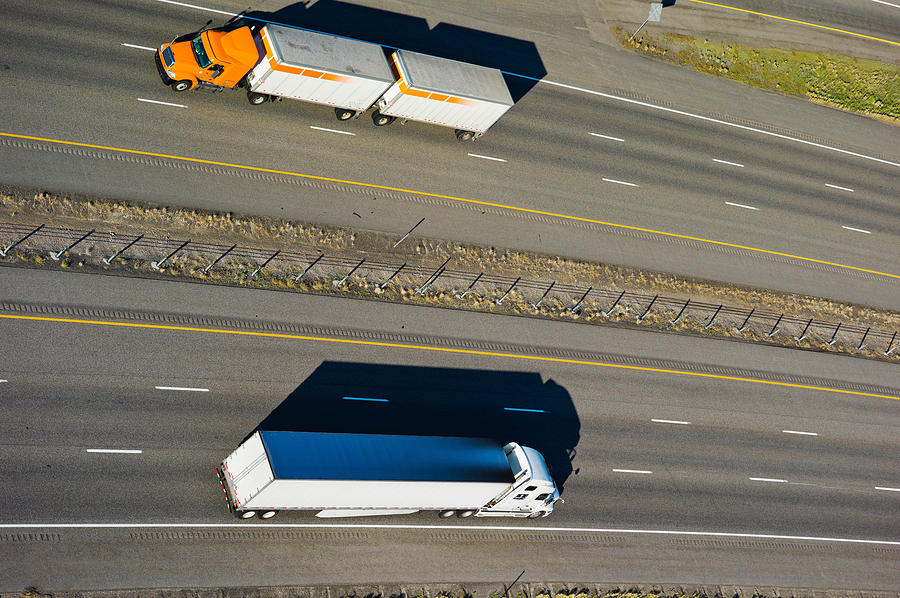 Color Image Photograph - Trucks Moving On A Highway, Interstate by Panoramic Images Color Image Photograph - Trucks Moving On A Highway, Interstate by Panoramic Images
