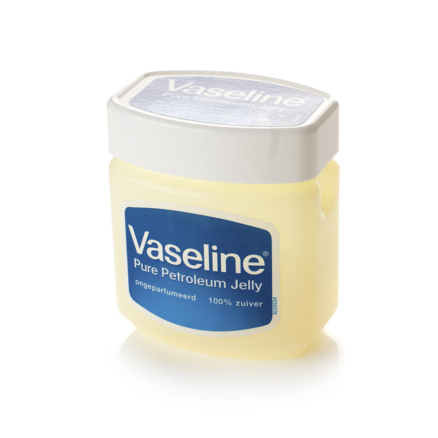 Tub of Vaseline on a white background Photograph by Lleerogers