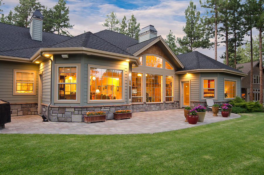 Twilight exterior of home and landscape Photograph by Chandlerphoto