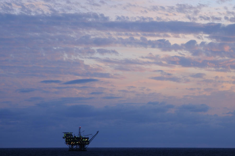 Twilight sky and oil rig Photograph by Bradford Martin