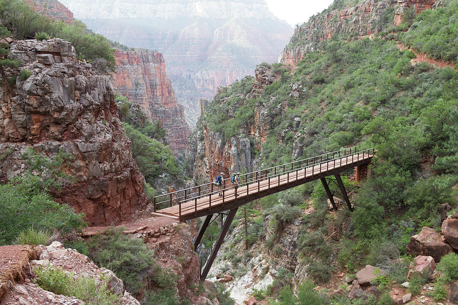 Grand Canyon National Park Photograph - Two Backpackers Standing On A Bridge by Whit Richardson