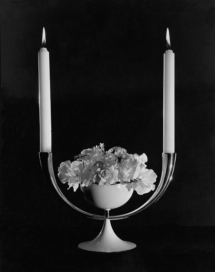 Two Burning Candles And And Some Flowers Photograph by John Rawlings