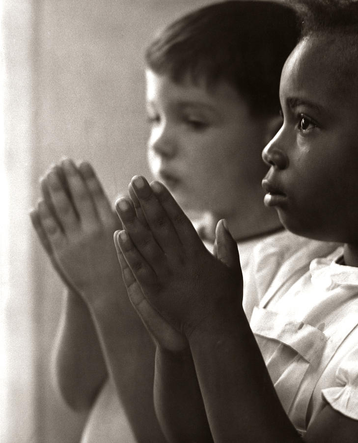 children praying in school