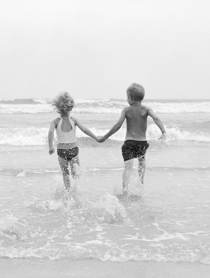 Two Children Running Into The Ocean Photograph by H Armstrong Roberts and ClassicStock