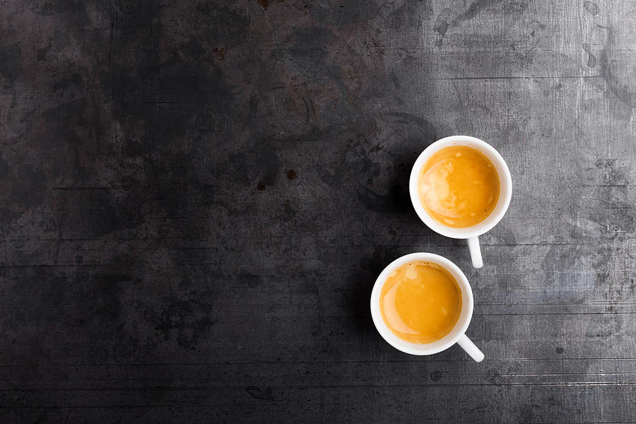Two cups of fresh espresso on gray background Photograph by Istetiana