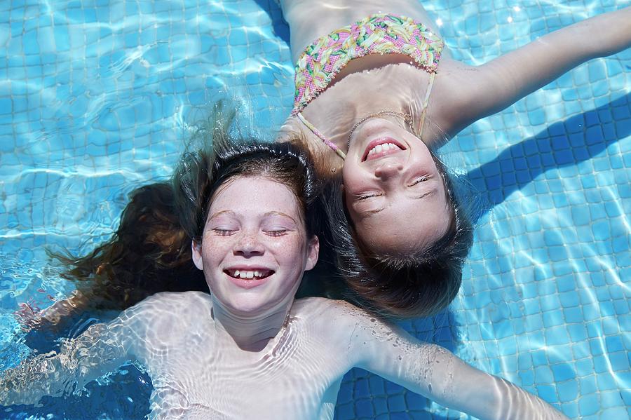 Two Girls Floating In Water Photograph by Ruth Jenkinson