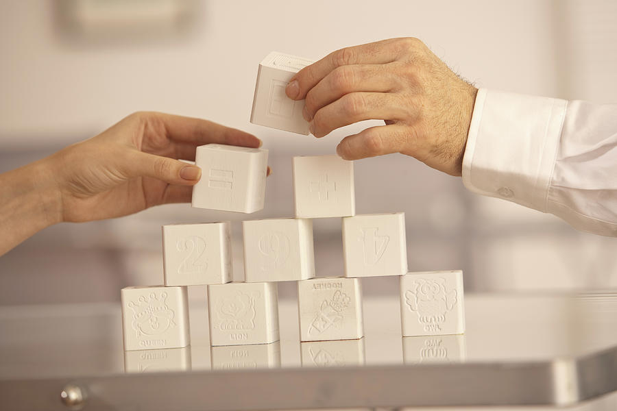 Two Hands Building Blocks Photograph by Comstock Images