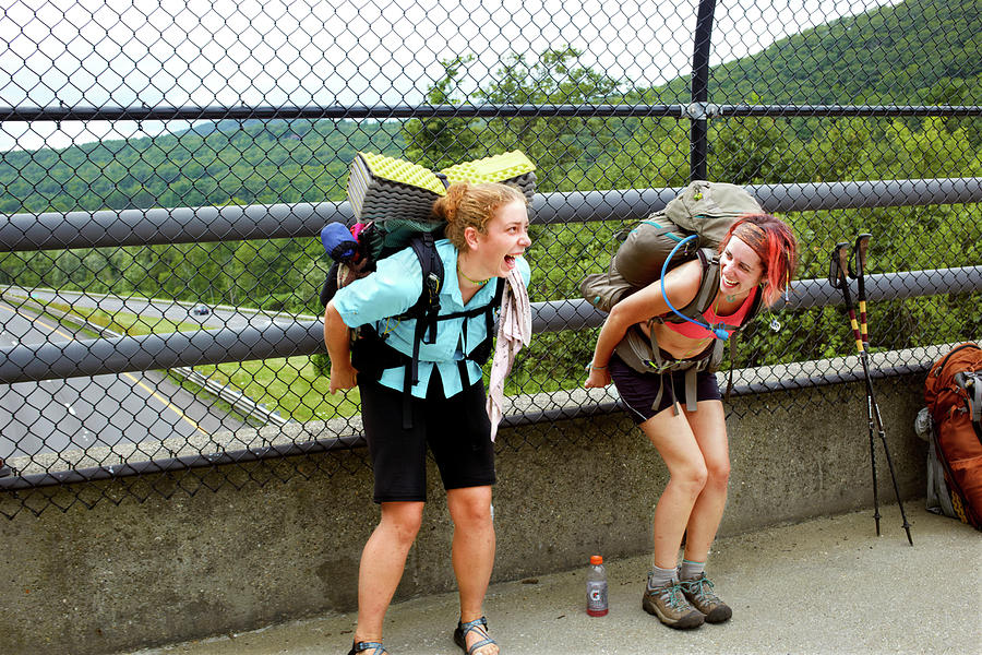 Two Hikers Mooning Traffic On I 90 by Michael D. Wilson.